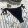 Black Katie tie-side bikini bottom for a flattering tan.